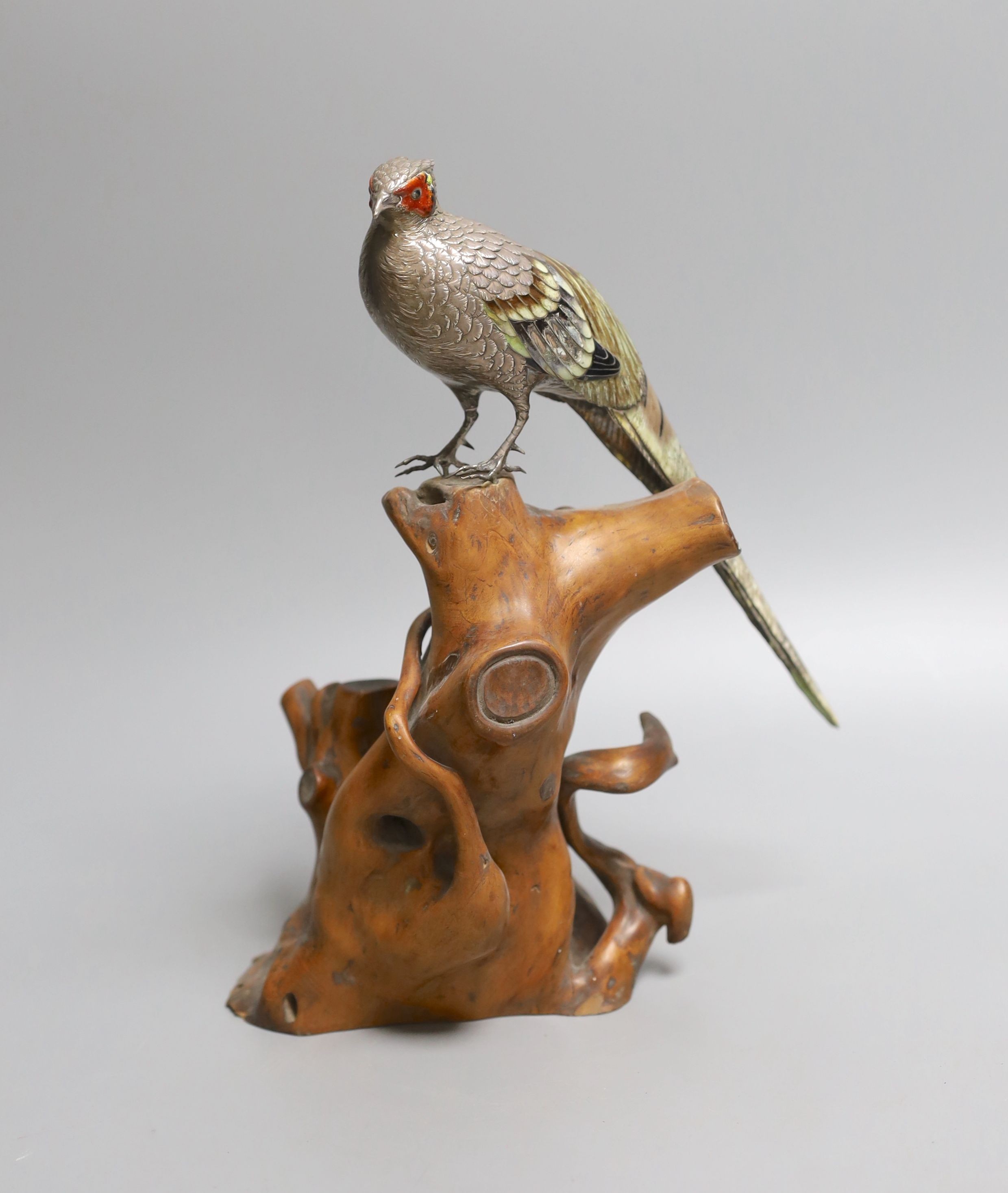 A Japanese? white metal and polychrome enamelled model of a pheasant on a root wood stand, bird 24.3cm, stand 17cm, enamel a.f., bird gross 197 grams.